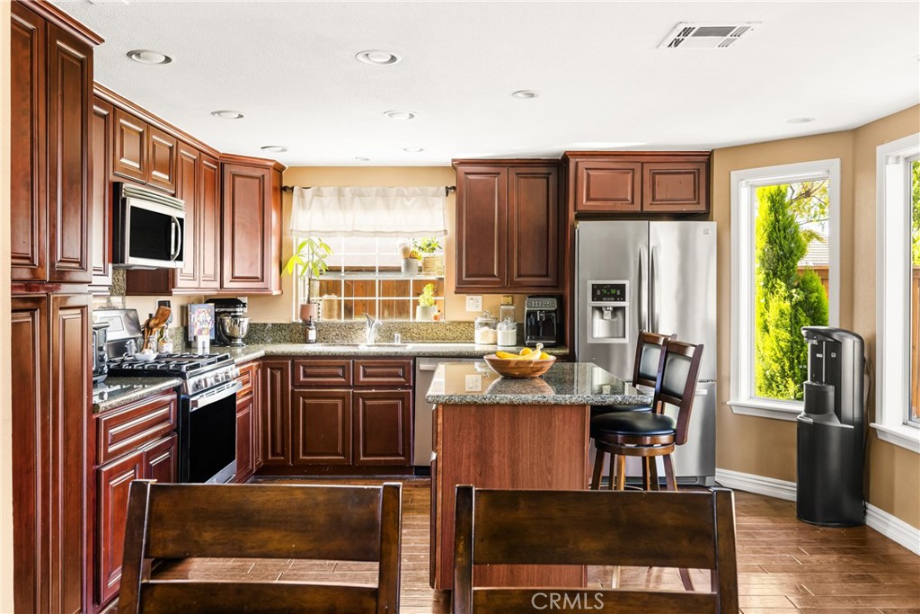 1985 Shady Brook Way Upland, CA 91784 - Photo 11 of 51 a kitchen with stainless steel appliances granite countertop a stove refrigerator sink and cabinets