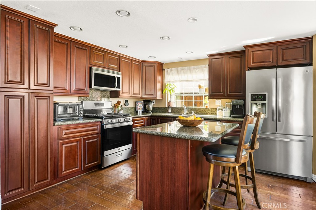 1985 Shady Brook Way Upland, CA 91784 - Photo 12 of 51 a kitchen with stainless steel appliances granite countertop a refrigerator stove microwave and sink