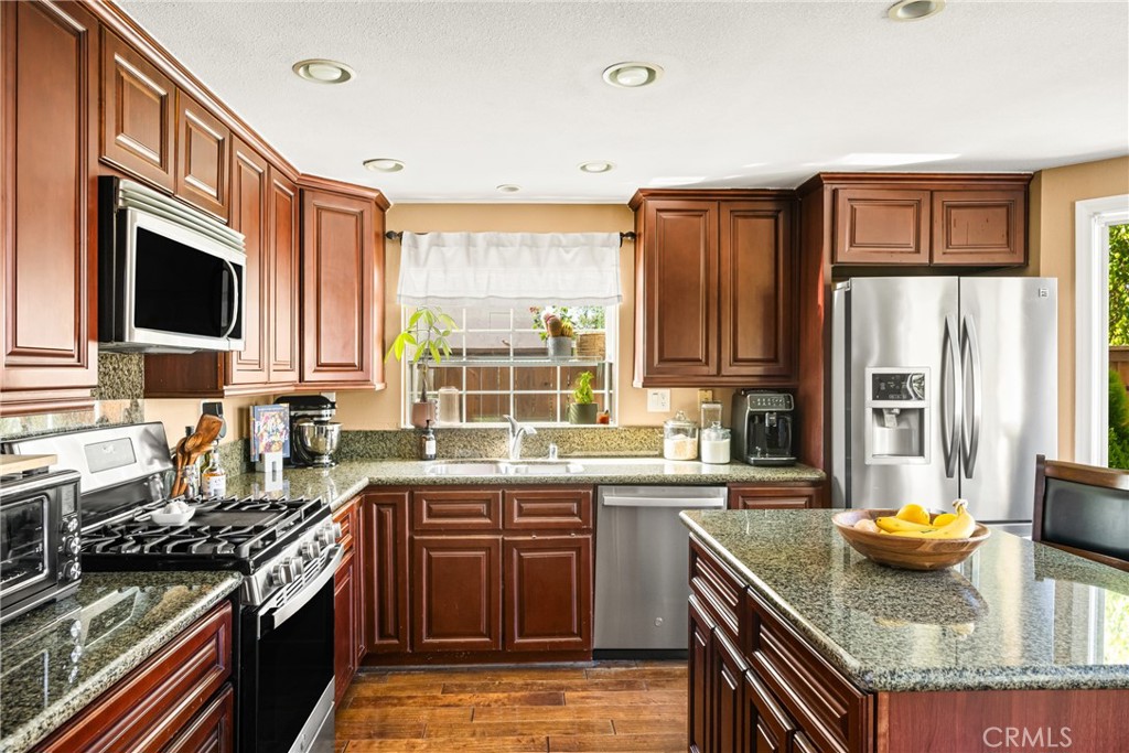 1985 Shady Brook Way Upland, CA 91784 - Photo 13 of 51 a kitchen with a stove a sink and a microwave