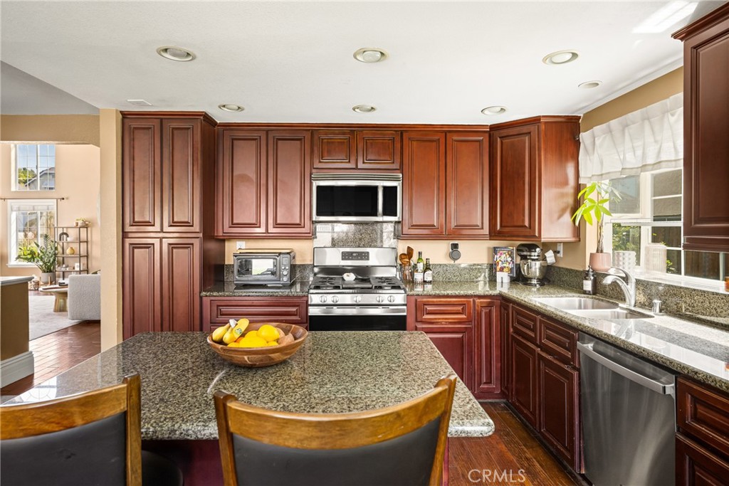1985 Shady Brook Way Upland, CA 91784 - Photo 14 of 51 a kitchen with stainless steel appliances granite countertop a sink stove and refrigerator