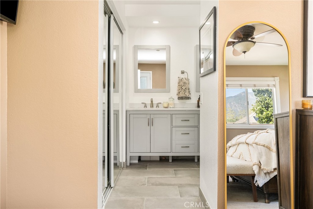 1985 Shady Brook Way Upland, CA 91784 - Photo 34 of 51 a en suite bathroom with a granite countertop sink and a mirror