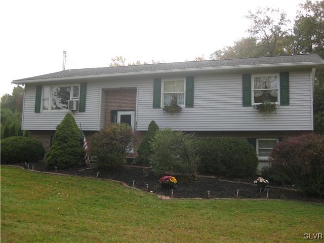 a view of a house with backyard sitting area and garden