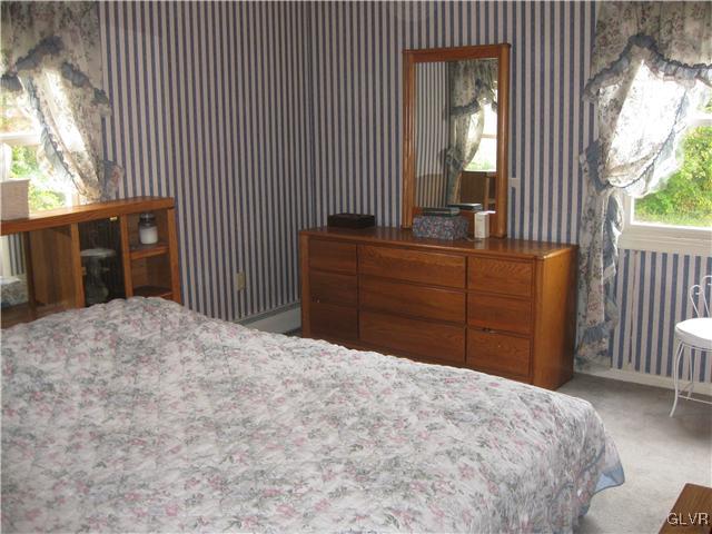 358 Blue Ridge Road Saylorsburg, PA 18353 - Photo 17 of 43 a bed room with a bed and a large mirror