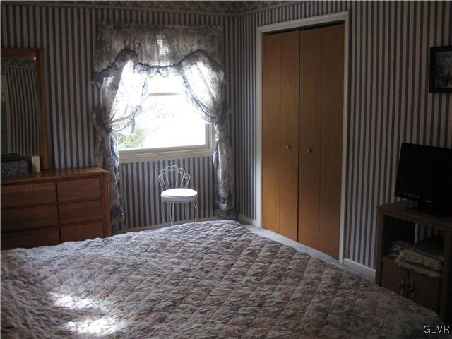 358 Blue Ridge Road Saylorsburg, PA 18353 - Photo 18 of 43 a bedroom with a bed and a flat tv screen on dresser