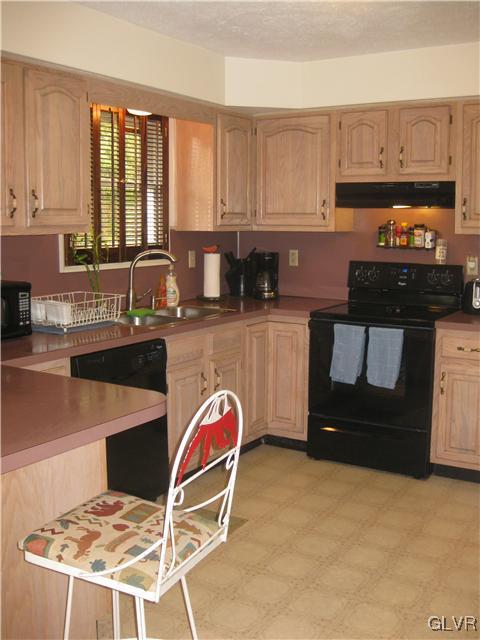 358 Blue Ridge Road Saylorsburg, PA 18353 - Photo 21 of 43 a kitchen with granite countertop a stove a sink and a white cabinets