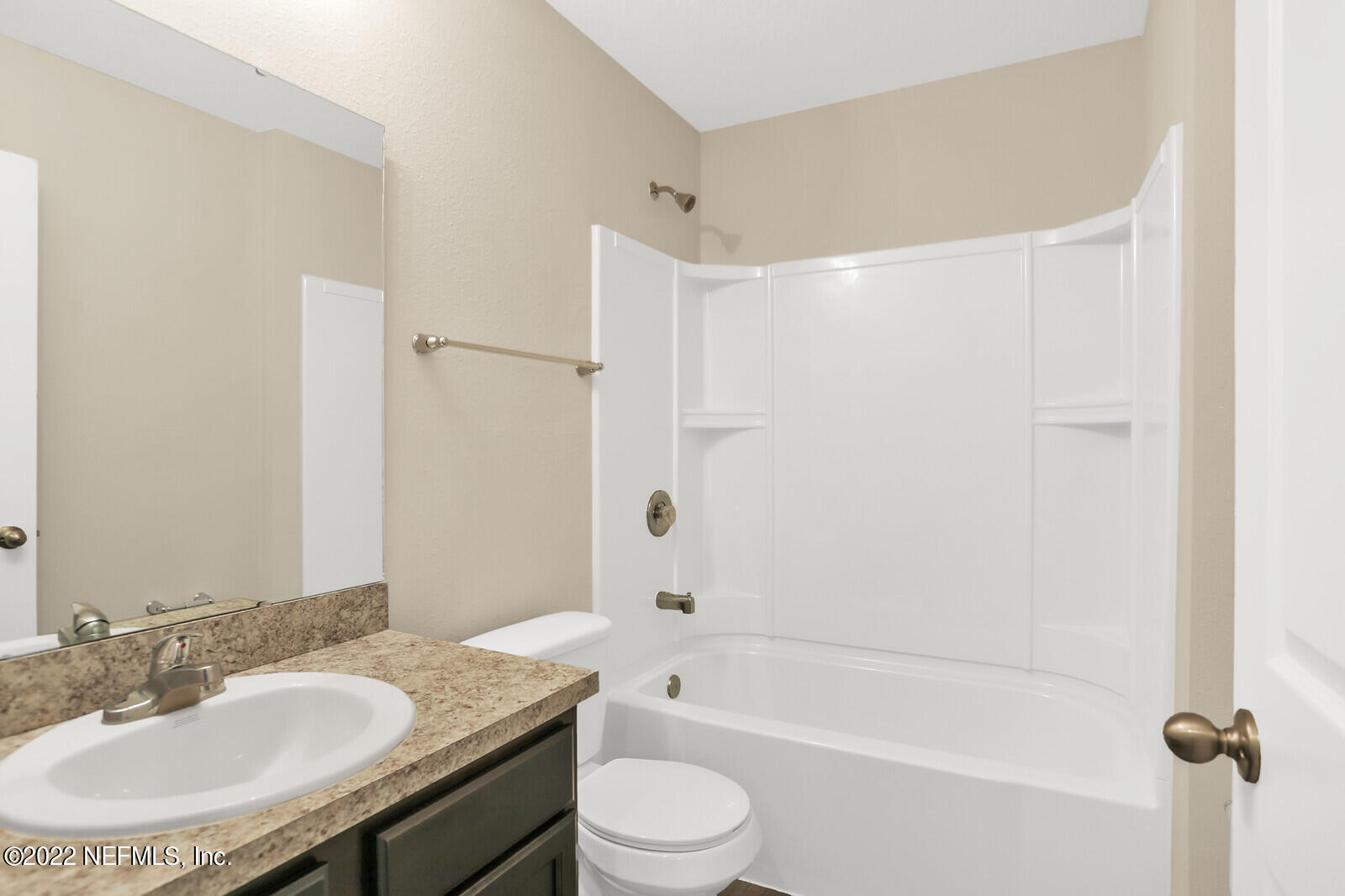 2235 3rd Avenue Jacksonville, FL 32208 - Photo 16 of 22 a bathroom with a granite countertop bathtub shower sink vanity mirror and toilet