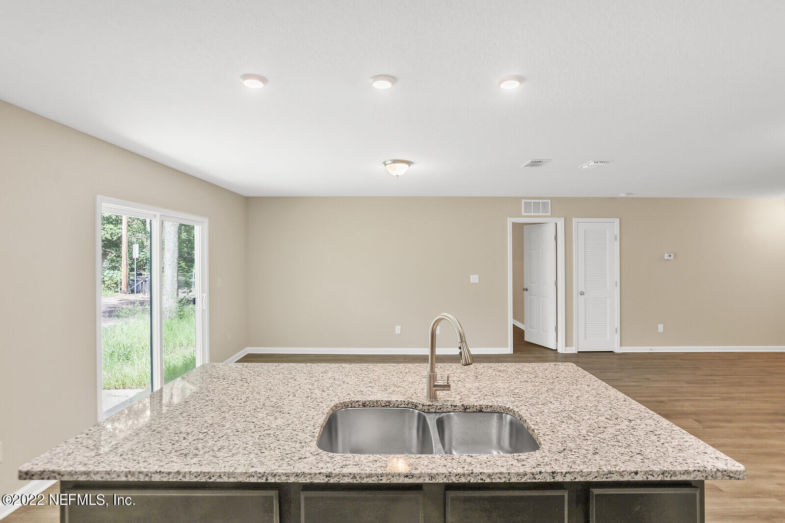 2235 3rd Avenue Jacksonville, FL 32208 - Photo 7 of 22 a kitchen with granite countertop a sink and a wooden floor