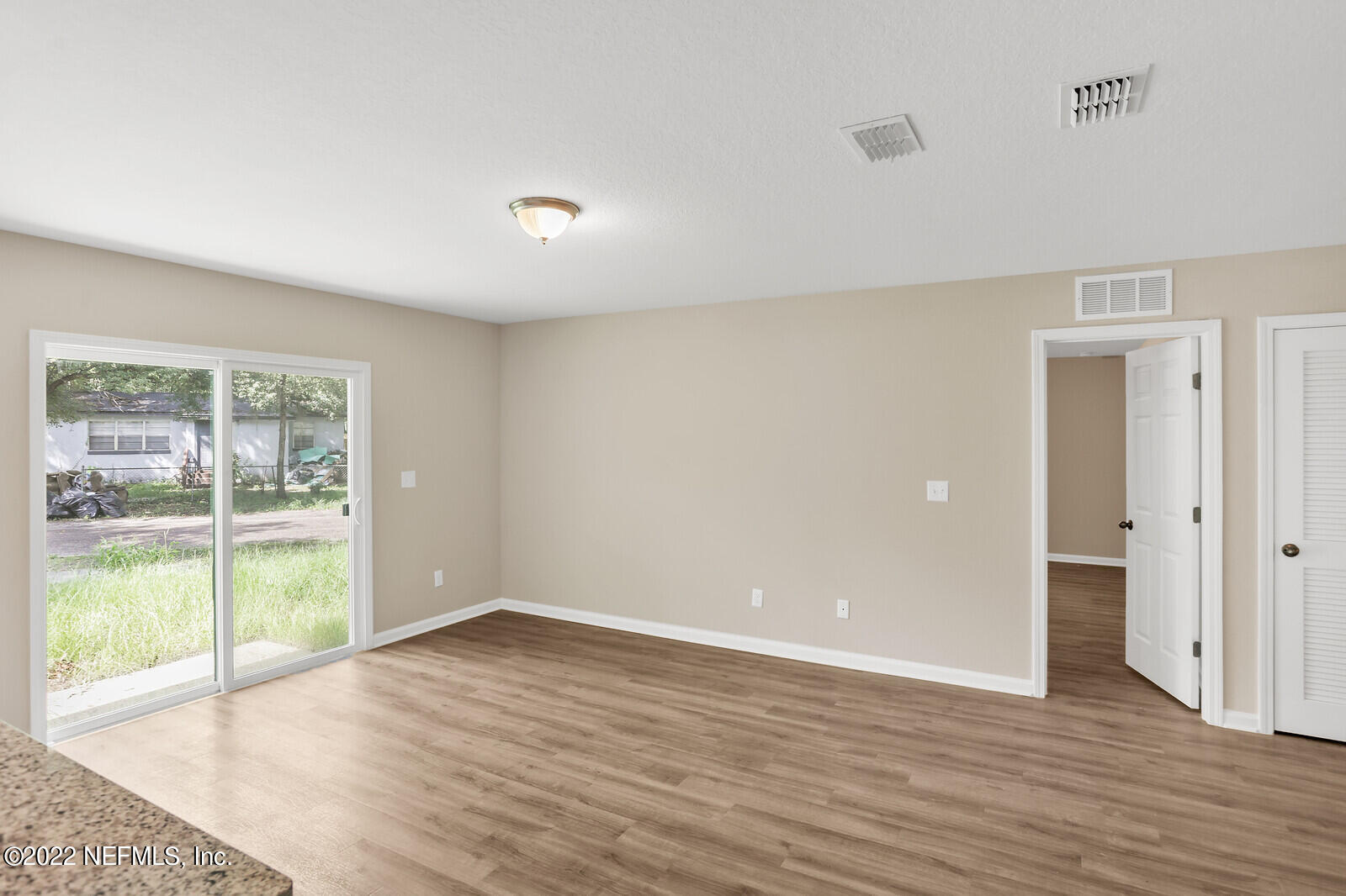 2235 3rd Avenue Jacksonville, FL 32208 - Photo 8 of 22 wooden floor in an empty room with a window