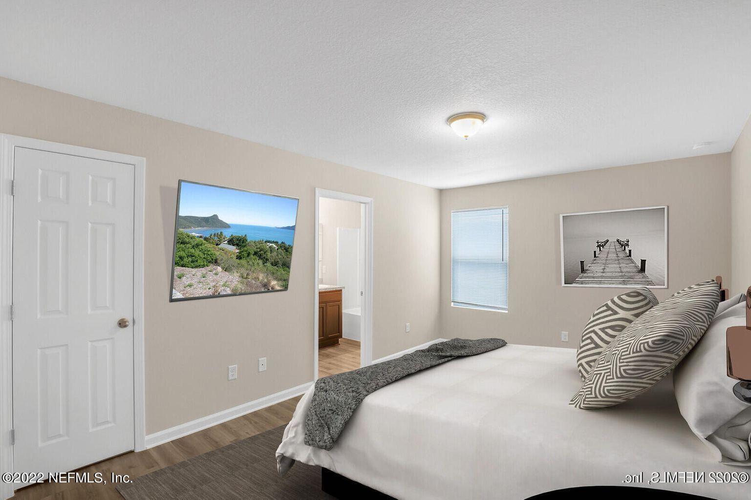 2235 3rd Avenue Jacksonville, FL 32208 - Photo 9 of 22 a bedroom with a bed and a painting on the wall