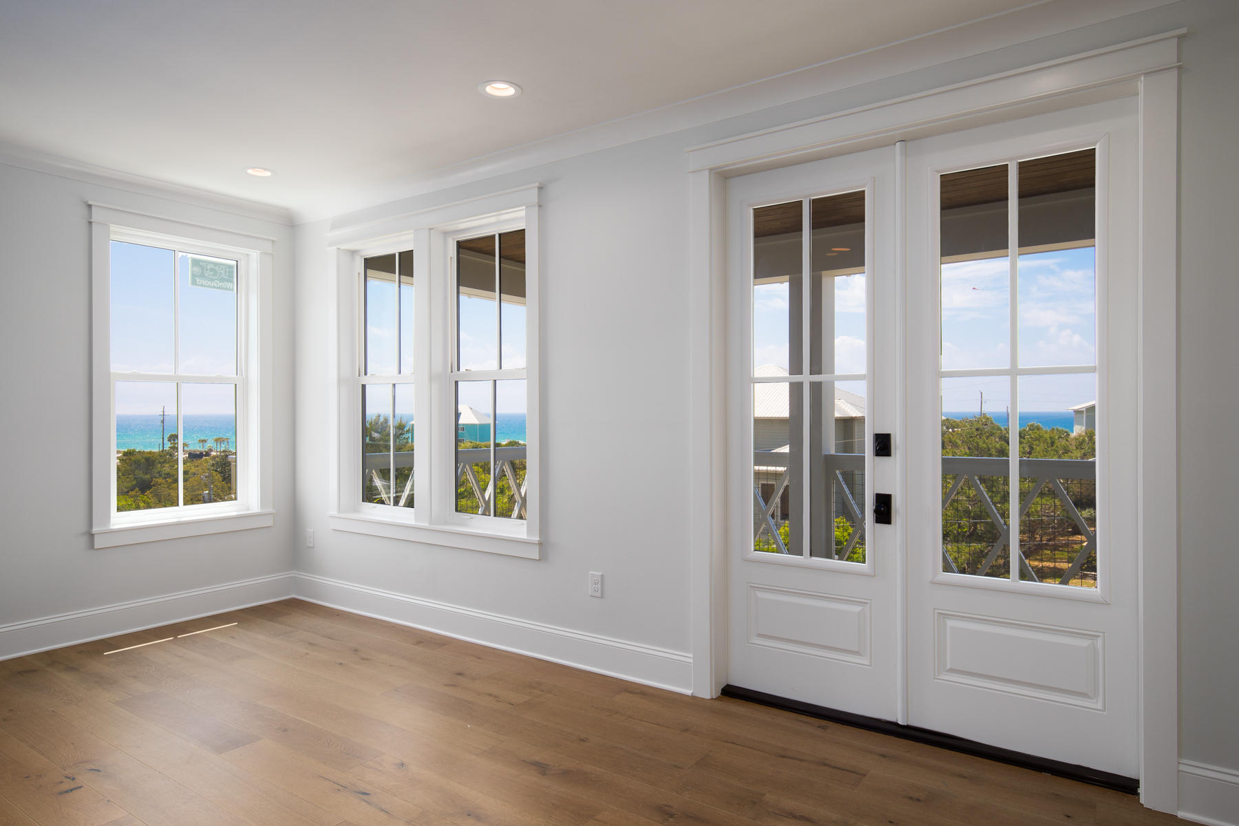68 Baird Road Santa Rosa Beach, FL 32459 - Photo 21 of 30 a view of an empty room with a window and wooden floor