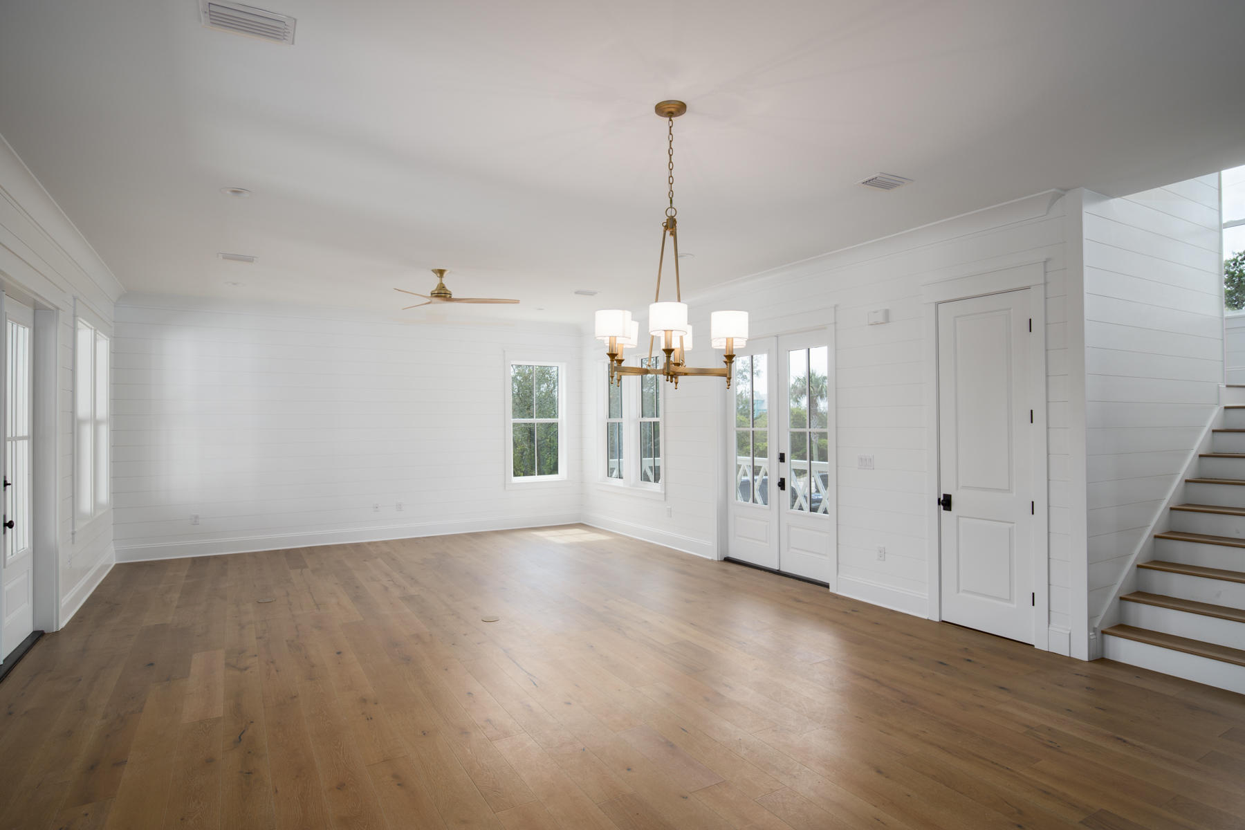 68 Baird Road Santa Rosa Beach, FL 32459 - Photo 9 of 30 a view of an empty room with wooden floor kitchen view and a window