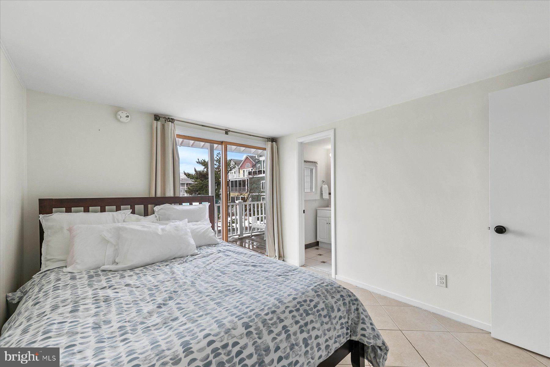 39589 Dune Road, Unit 59 Bethany Beach, DE 19930 - Photo 10 of 34 a bedroom with a bed and window