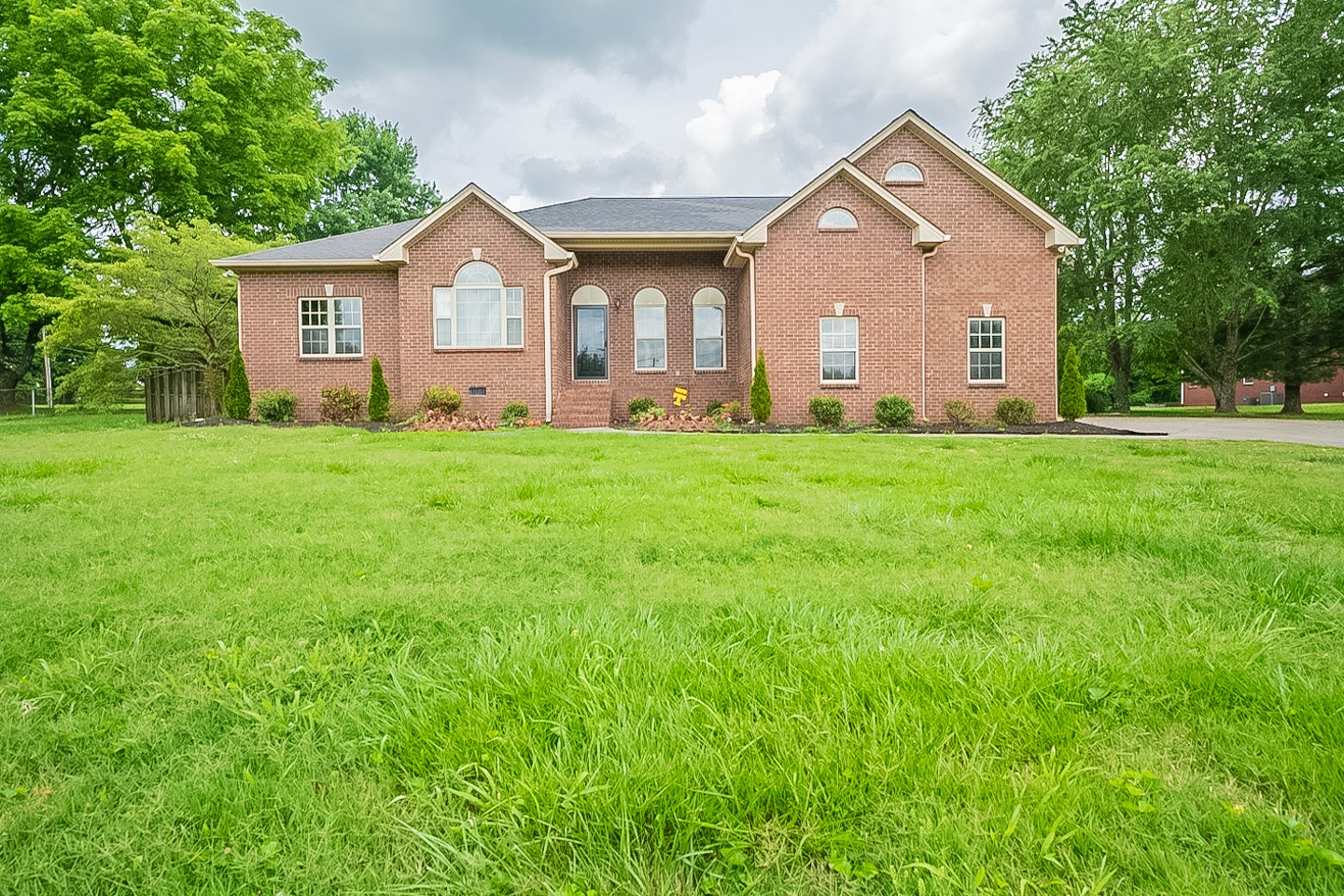 227 Beckwith Road Mount Juliet, TN 37122 - Photo 1 of 34 a view of a yard in front of a house with large trees