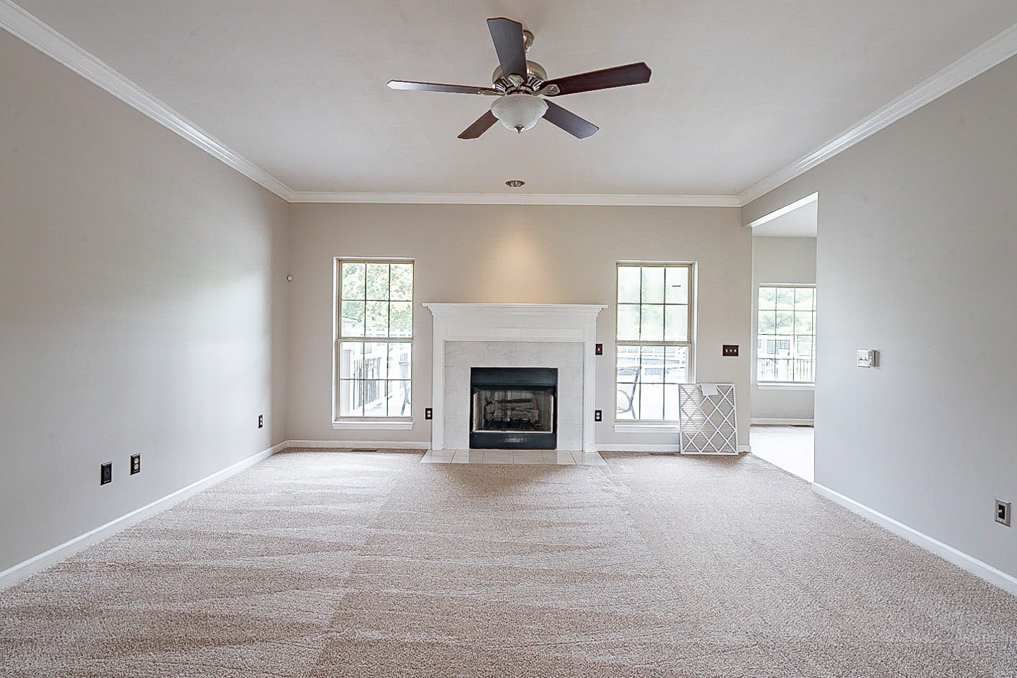 227 Beckwith Road Mount Juliet, TN 37122 - Photo 5 of 34 a view of a livingroom with a fireplace a ceiling fan and windows