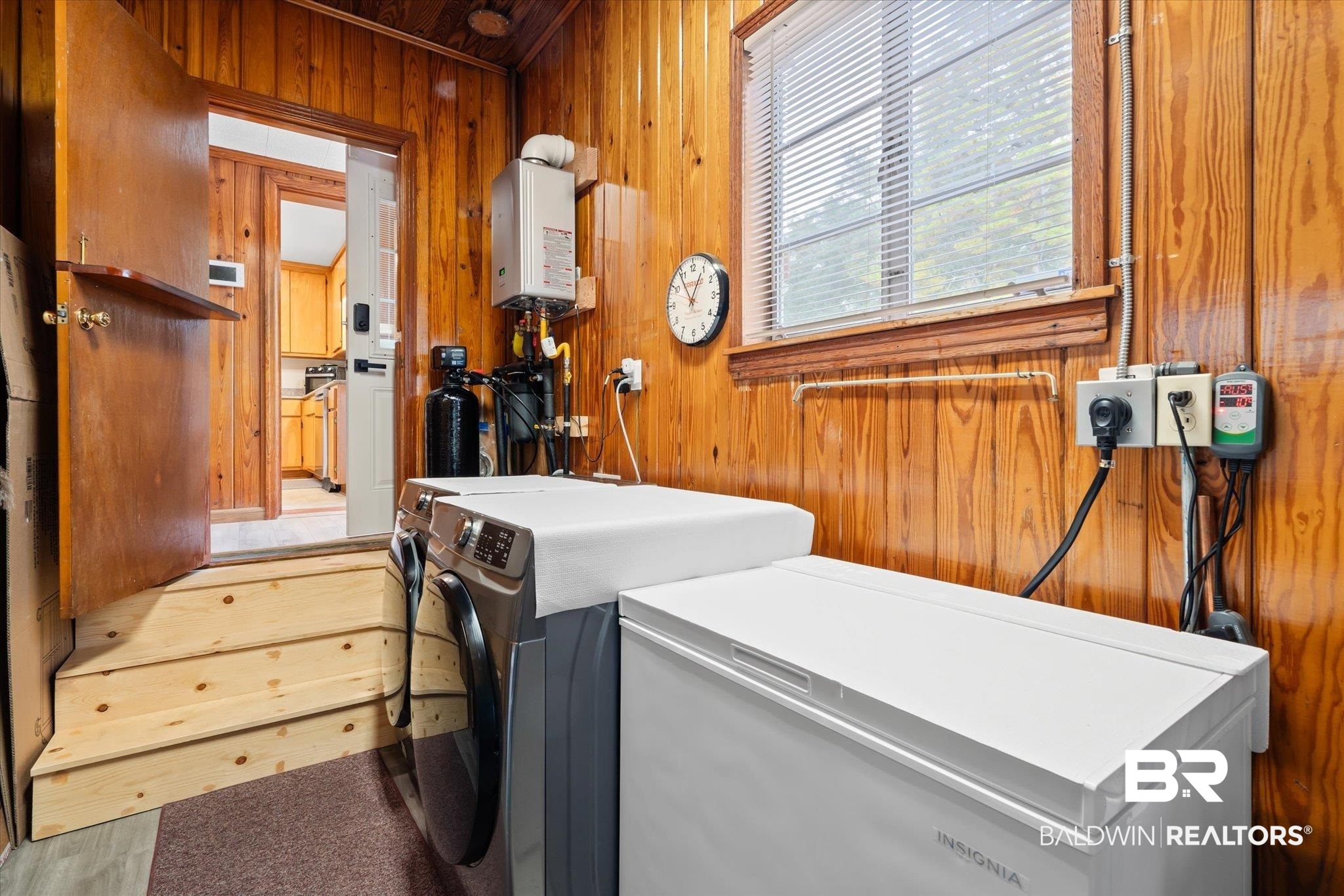 162 Bit And Spur Terrace Mobile, AL 36608 - Photo 21 of 29 Washroom with hardwood / wood-style floors, wooden walls, and independent washer and dryer