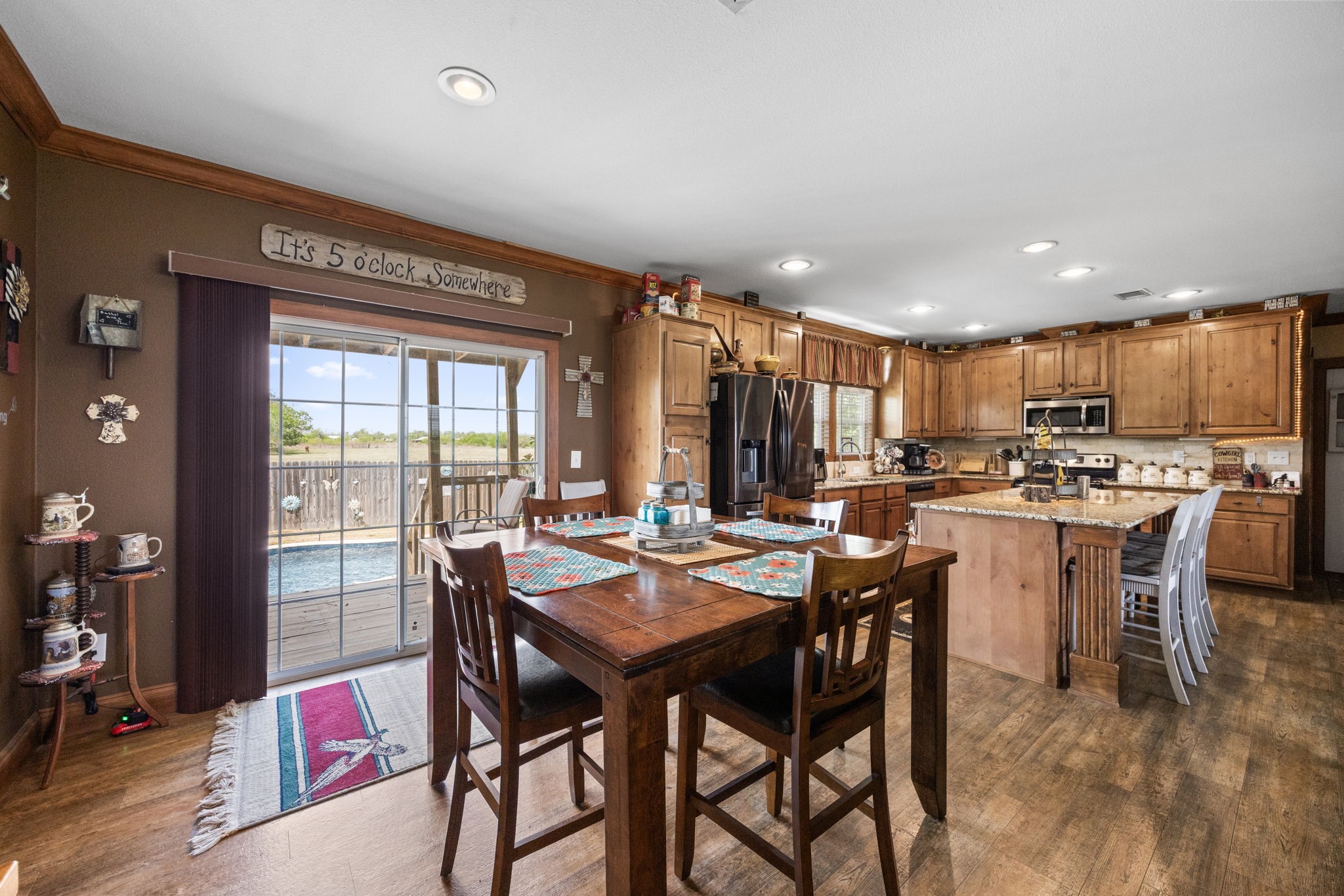 3518 Oil Field Road Bellville, TX 77418 - Photo 11 of 40 a dining room with a table chairs and a kitchen view