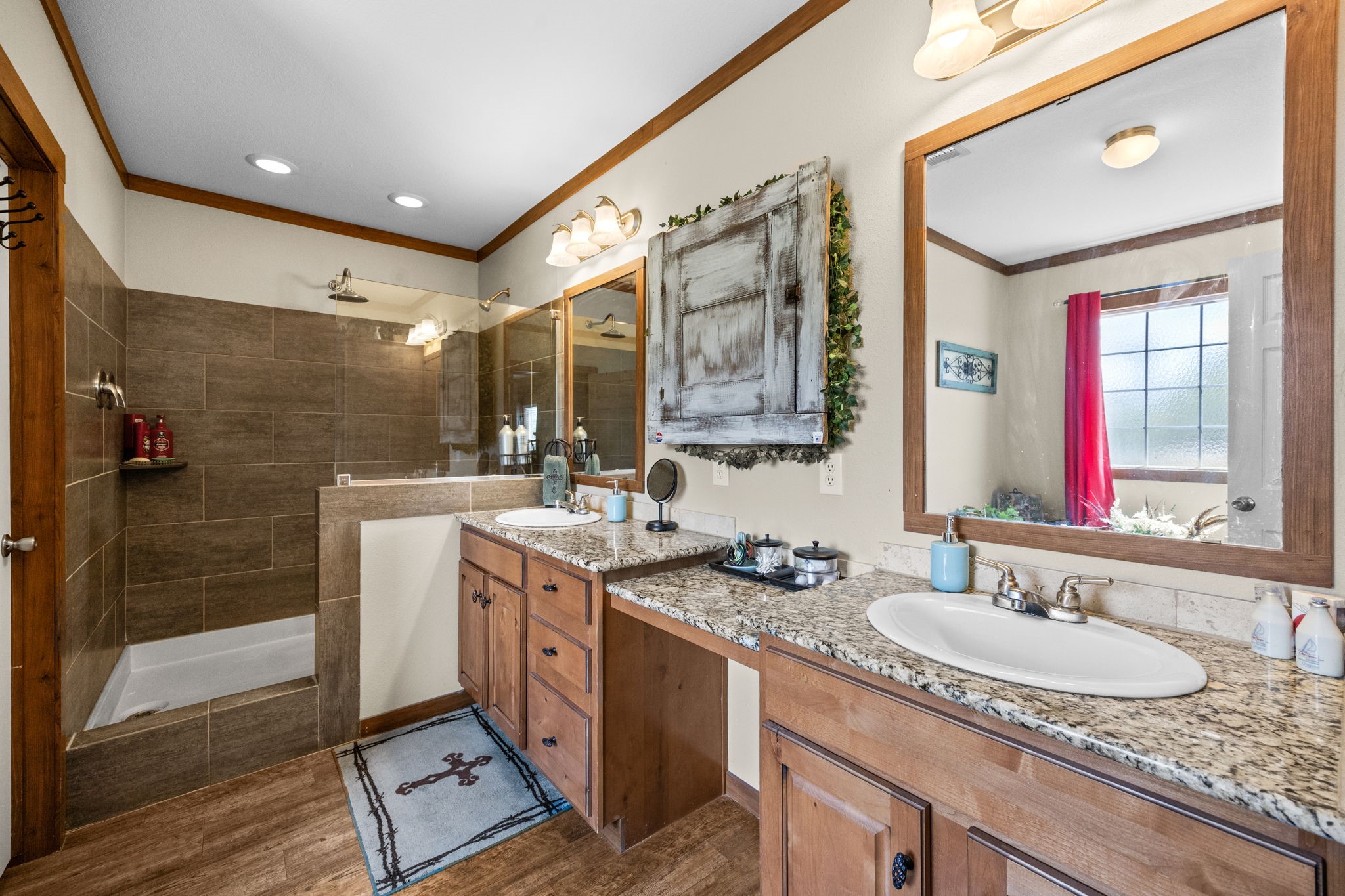 3518 Oil Field Road Bellville, TX 77418 - Photo 17 of 40 a bathroom with a granite countertop sink a mirror and shower