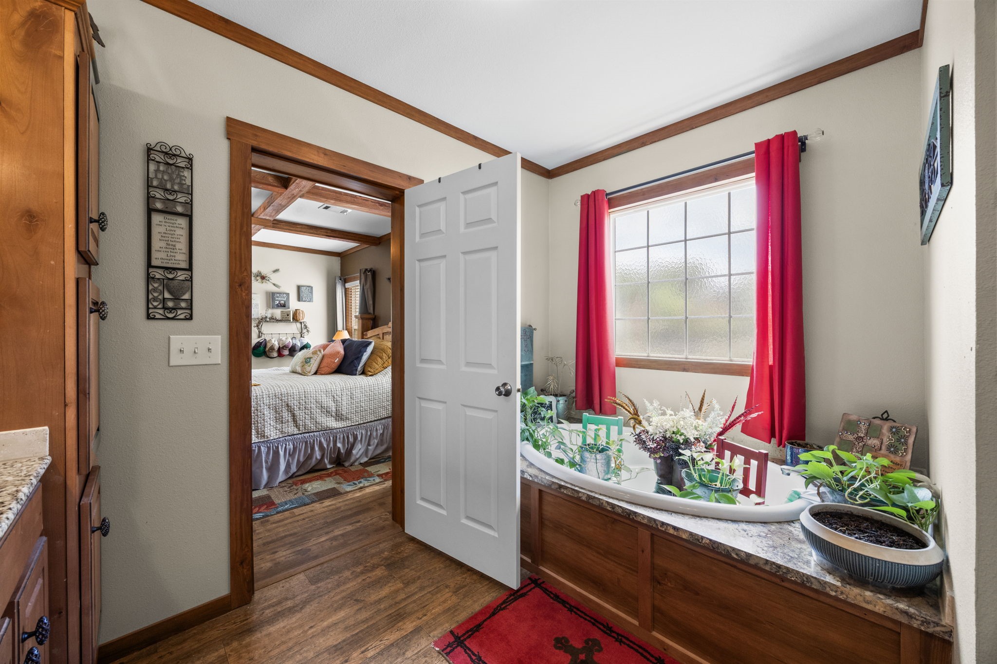 3518 Oil Field Road Bellville, TX 77418 - Photo 18 of 40 a room with wooden floor and a potted plant