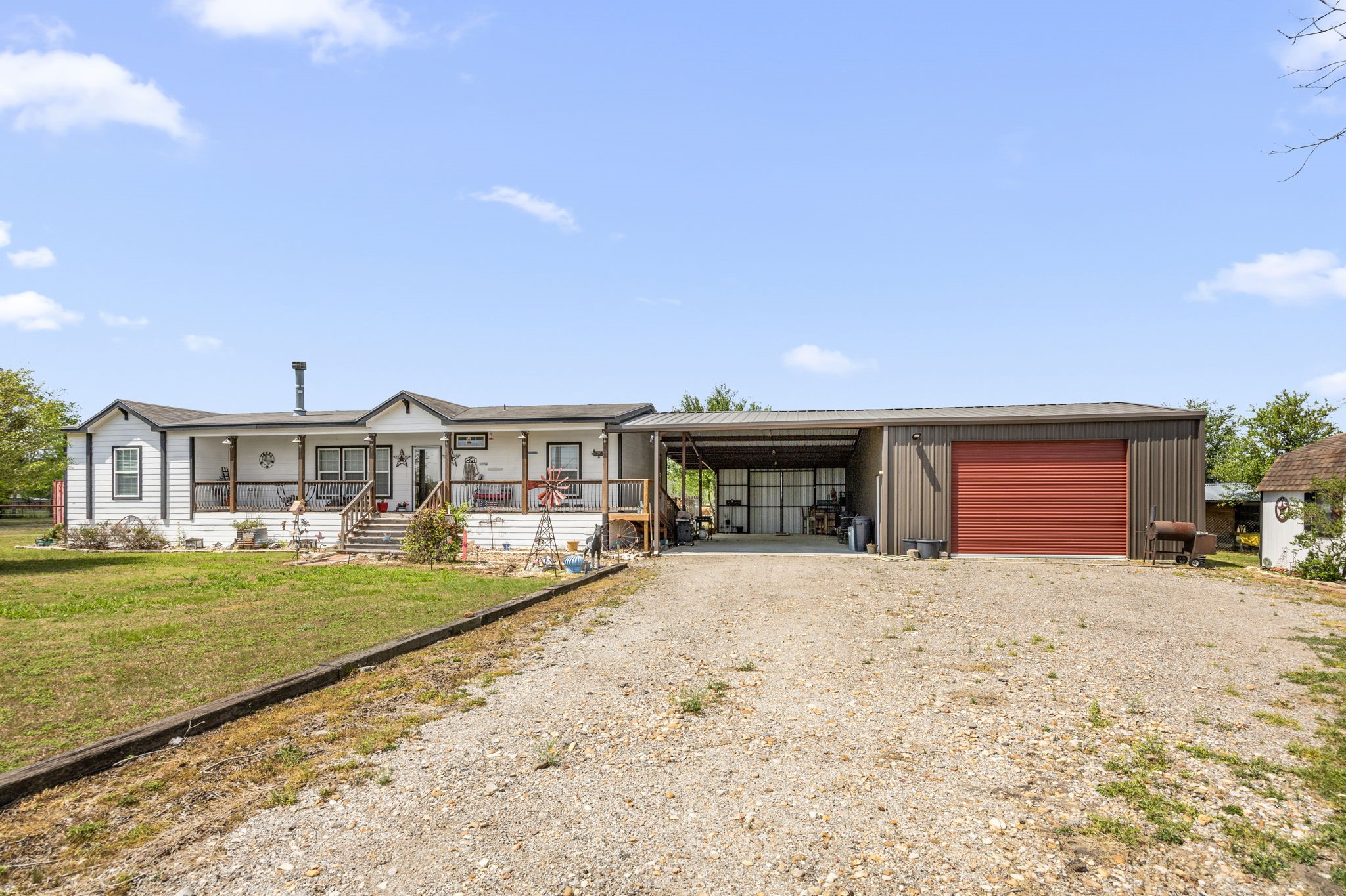 3518 Oil Field Road Bellville, TX 77418 - Photo 4 of 40 a front view of a house with a yard outdoor seating and garage