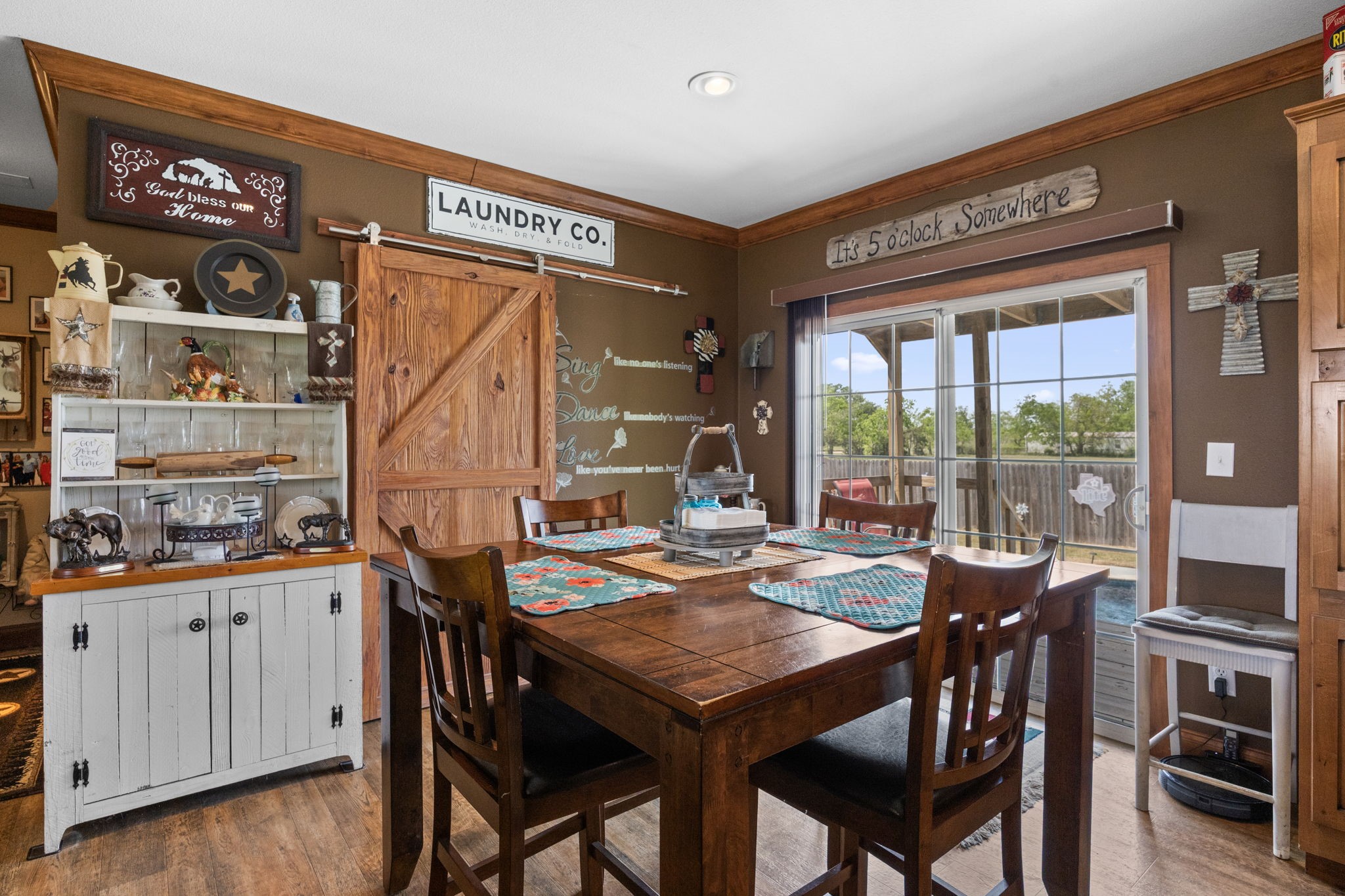 3518 Oil Field Road Bellville, TX 77418 - Photo 10 of 40 a view of a dining area with furniture window and wooden floor