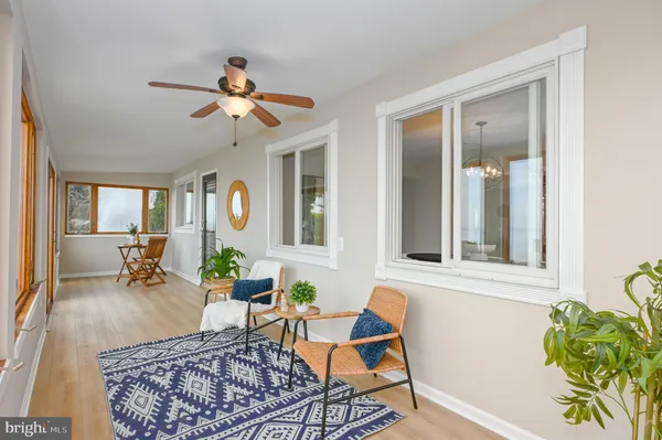 a view of a room with furniture and wooden floor