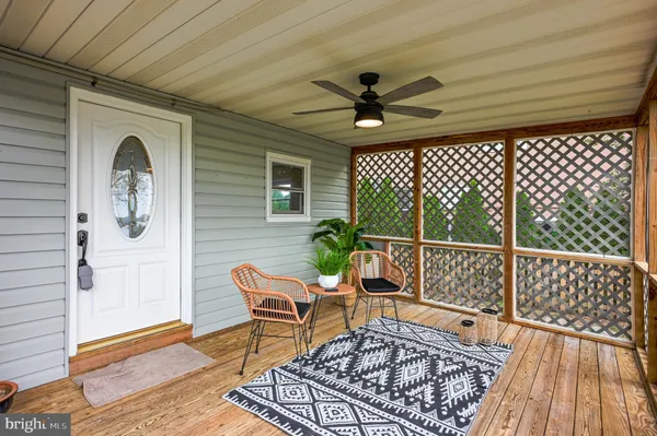 a living room with furniture a table and wooden floor