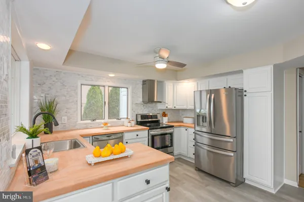 a living room with furniture potted plant and a large window