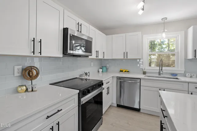 a kitchen with a sink cabinets and window
