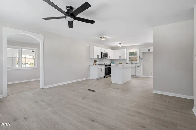 a view of a kitchen with a sink and a refrigerator