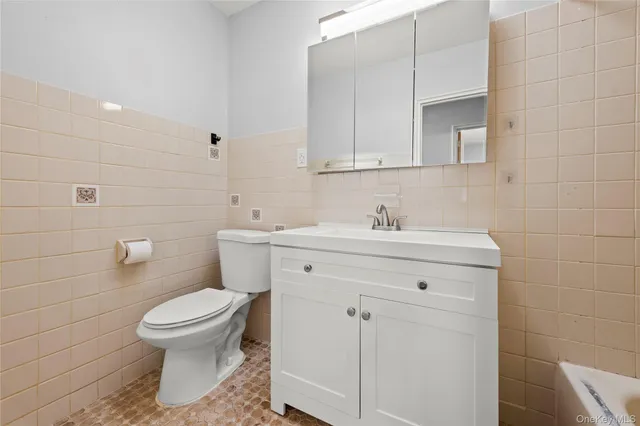 a bathroom with a sink toilet and vanity