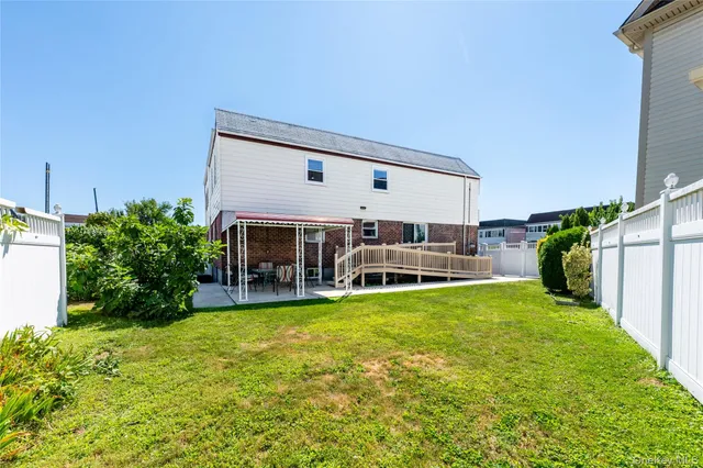 a view of a house with garden and a patio