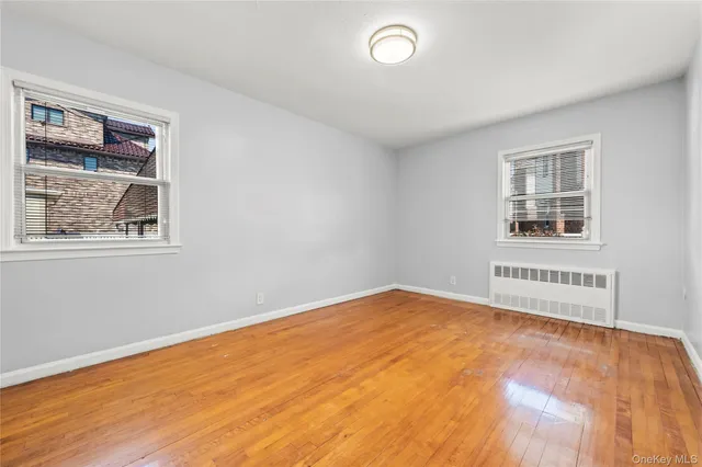 a view of an empty room with a fireplace and a window