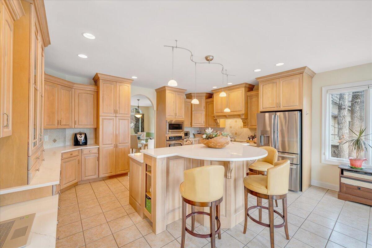 2580 Lakewood Forest Road Moneta, VA 24121 - Photo 22 of 103 a kitchen with stainless steel appliances kitchen island granite countertop a refrigerator a stove a sink and white cabinets with wooden floor