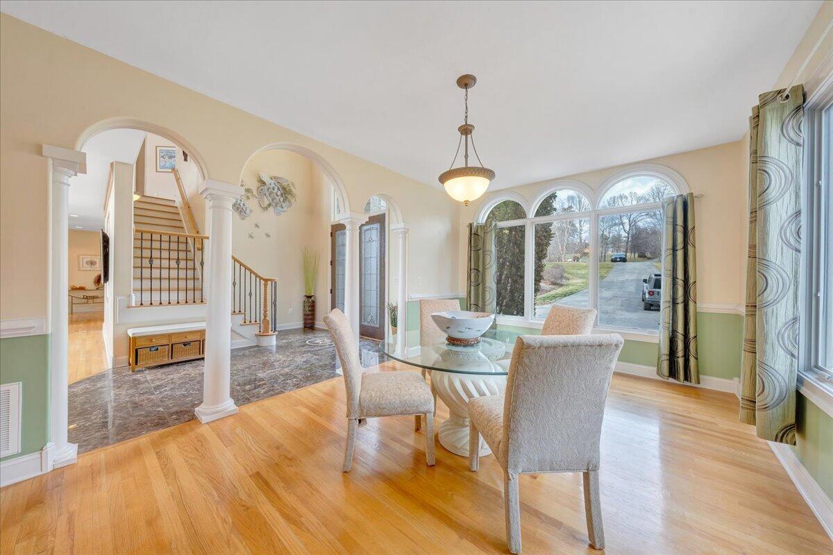 2580 Lakewood Forest Road Moneta, VA 24121 - Photo 37 of 103 a view of a dining room with furniture a chandelier and wooden floor