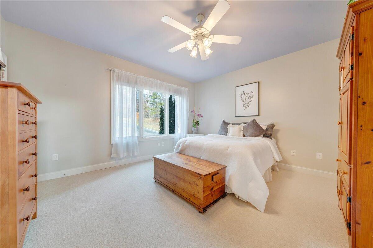 2580 Lakewood Forest Road Moneta, VA 24121 - Photo 45 of 103 a spacious bedroom with a bed painting on wall and a large window