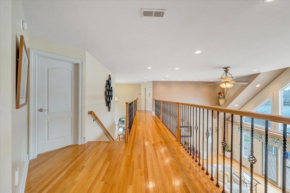 2580 Lakewood Forest Road Moneta, VA 24121 - Photo 65 of 103 a view of a hallway with wooden floor and stairs