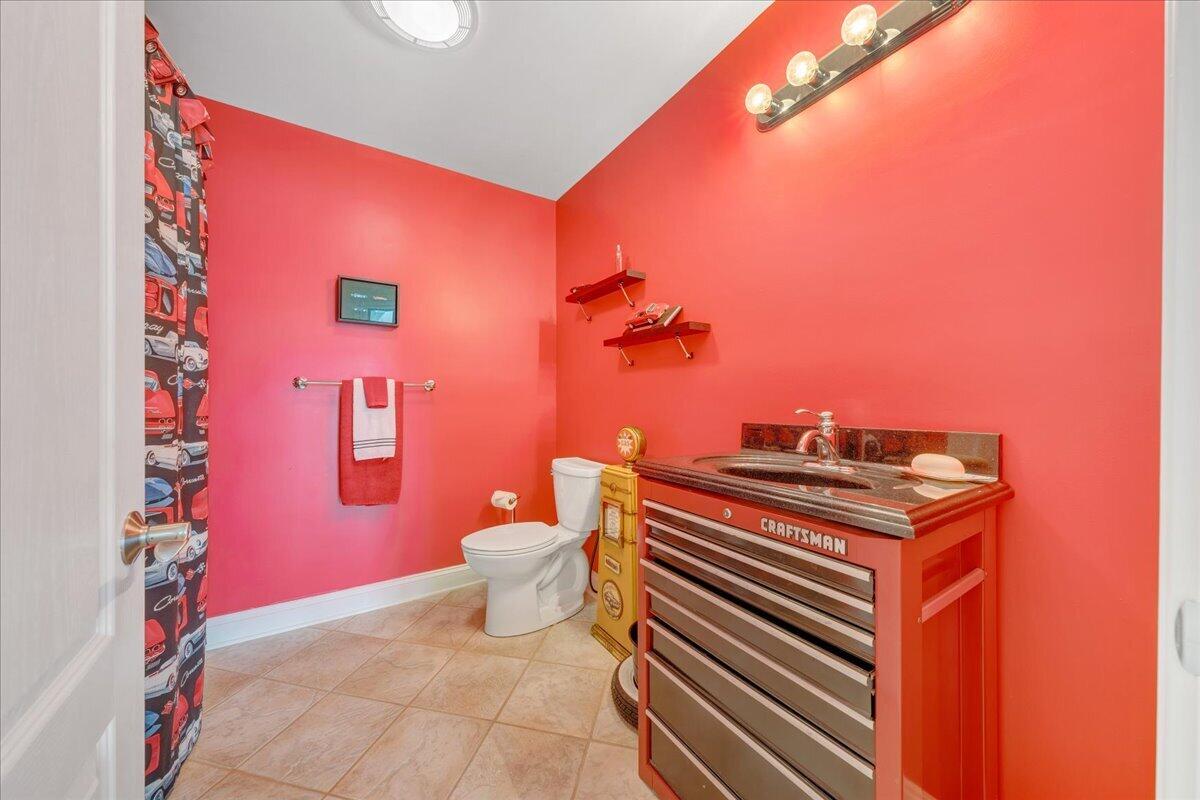 2580 Lakewood Forest Road Moneta, VA 24121 - Photo 75 of 103 a bathroom with a toilet a sink and mirror