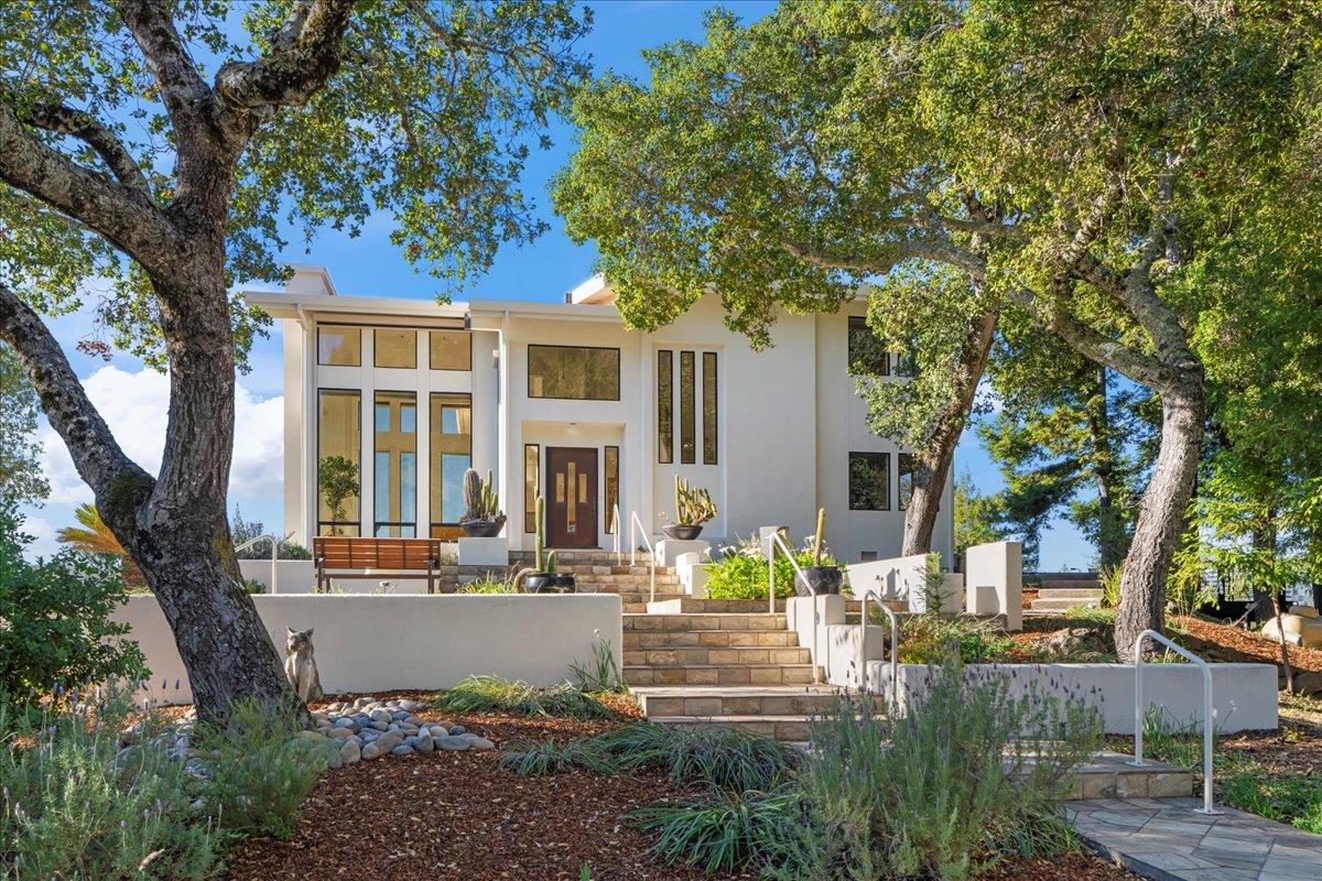 a front view of a house with a tree s