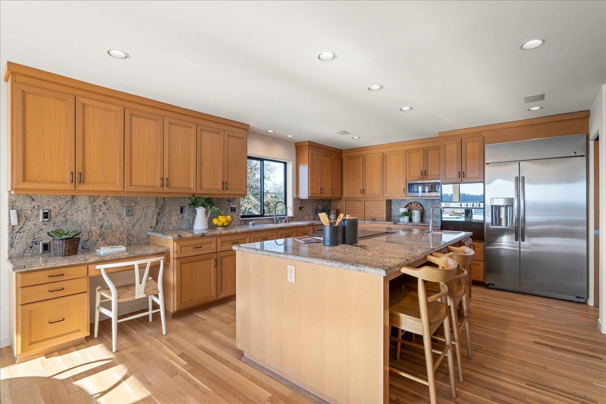 7 No Name Road Los Gatos, CA 95033 - Photo 14 of 49 a kitchen with stainless steel appliances granite countertop a refrigerator a stove a sink a dining table and chairs with wooden floor