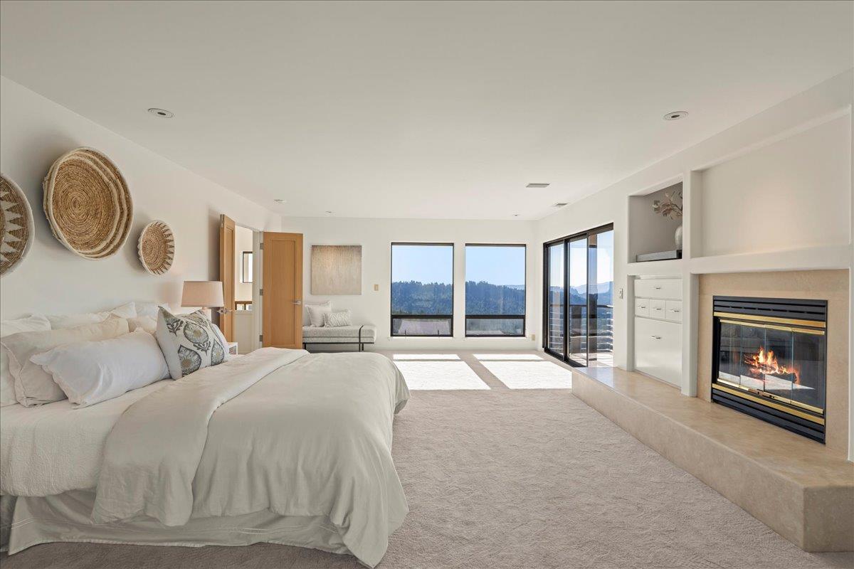 7 No Name Road Los Gatos, CA 95033 - Photo 28 of 49 a spacious bedroom with a bed and a fireplace