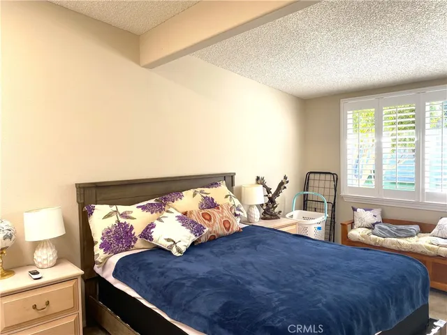 a bedroom with bed and window