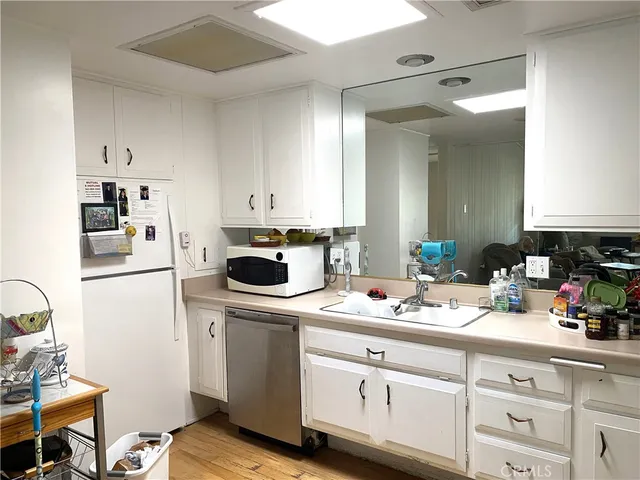 a kitchen with a sink cabinets and appliances