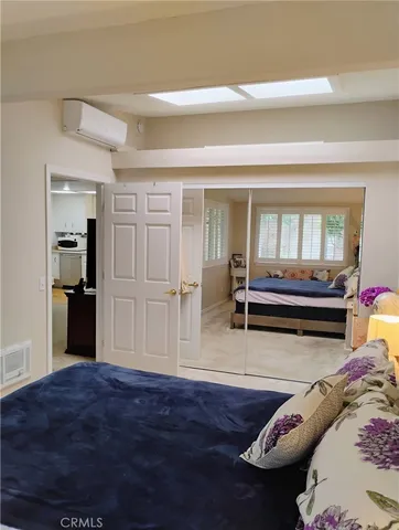 a view of a bedroom with furniture and wooden floor