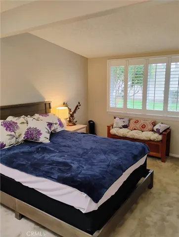 a bed room with a bed and a window