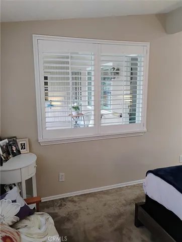 a room with a window bed and couch