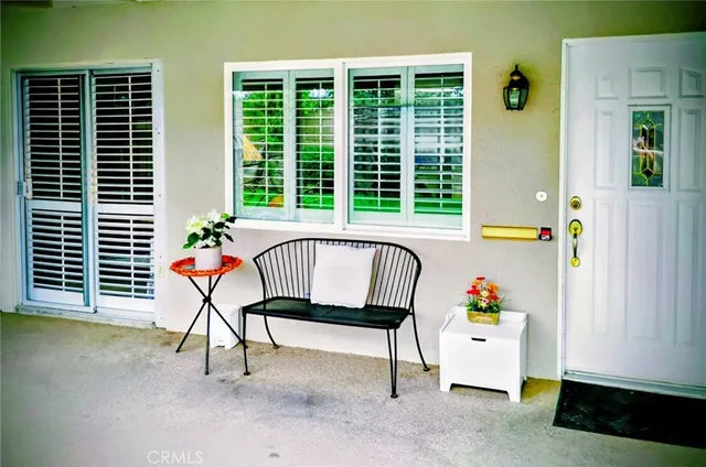 a house view with a seating space and a potted plant