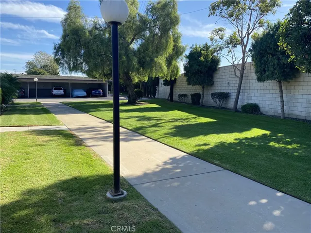 a view of a swimming pool with a yard