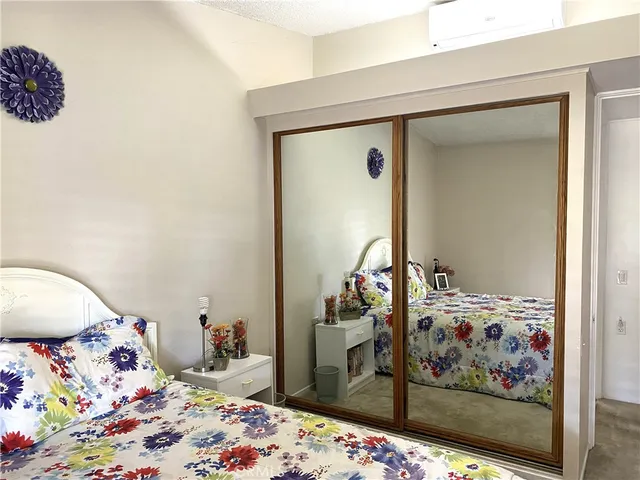 a bedroom with bed and wooden floor