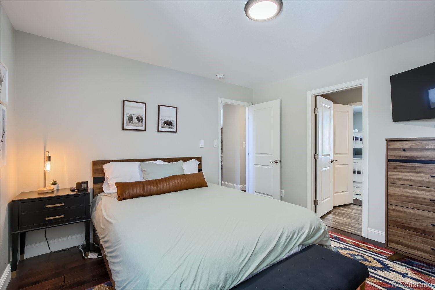 27732 Squaw Pass Road Evergreen, CO 80439 - Photo 12 of 33 a bedroom with a bed and a television