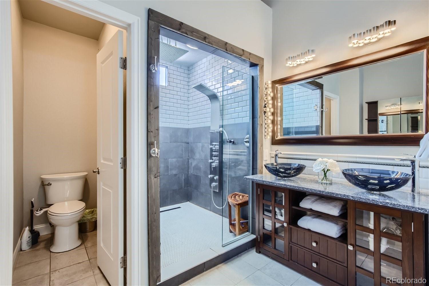 27732 Squaw Pass Road Evergreen, CO 80439 - Photo 16 of 33 a bathroom with a sink and a mirror